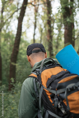 A young guy with a backpack in the cap, traveller in the woods, Hiking, Forest, Journey © Max