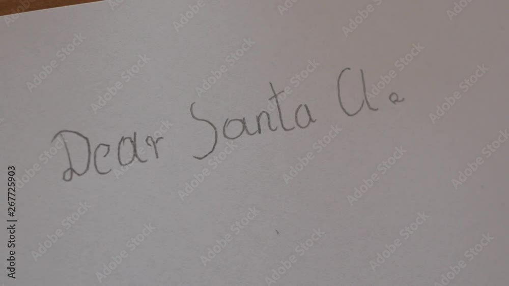 child writes, writing a letter to Santa Claus, child's hand child writes, writing a letter to Santa Claus, child's hand