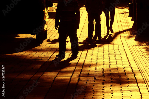 Close up image of silhouetted people walking on city street in Antalya, Turkey