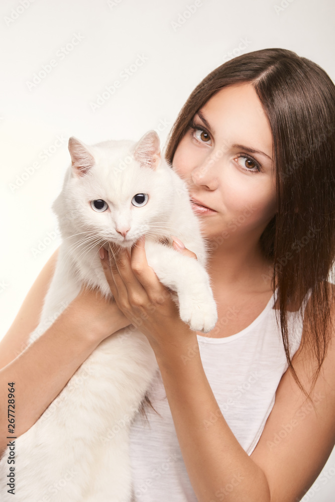 Young woman with white cat. Happy girl allergy animal. Veterinarian concept