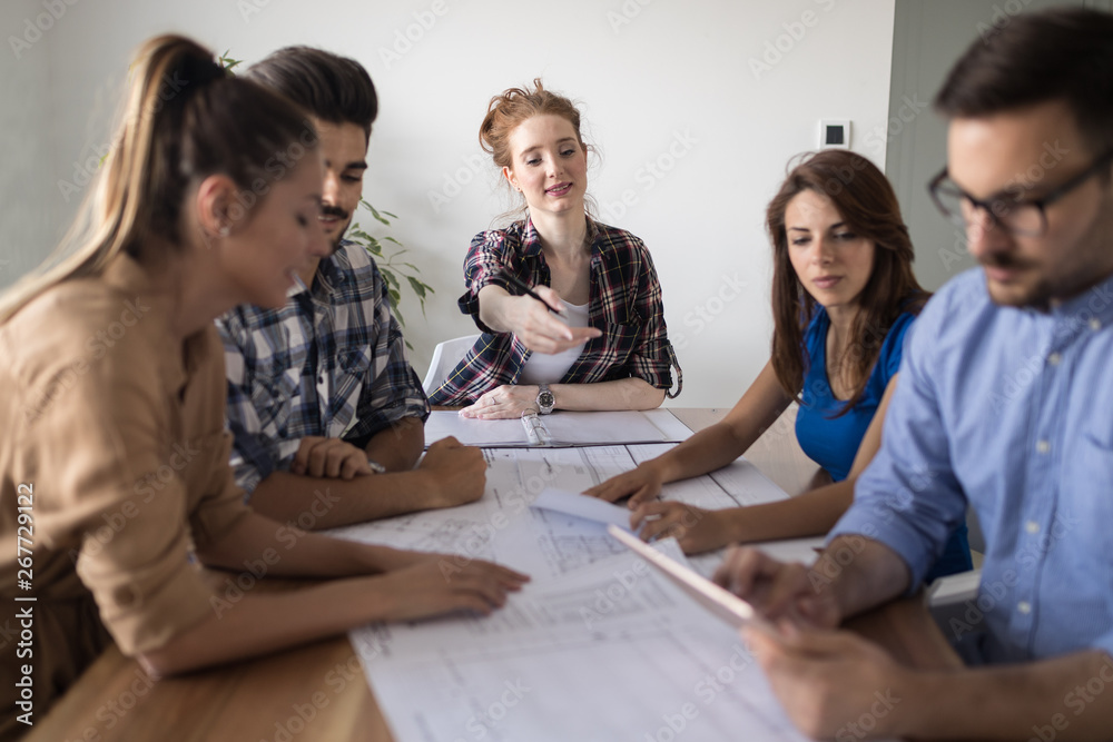 Image of business partners discussing documents and ideas