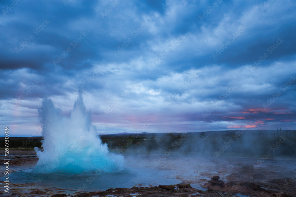 Strokkur Geysir Eruption with Dark Cloudy Sky, Iceland Strokkur Geysir Eruption with Dark Cloudy Sky, Iceland