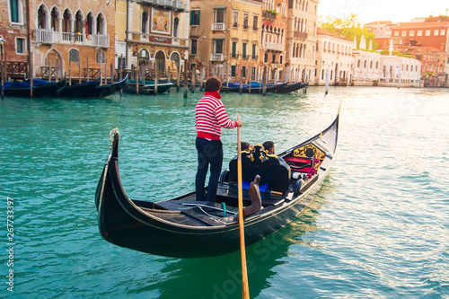 Gondolier carries tourists on gondola Grand Canal of Venice, Italy © dzmitrock87