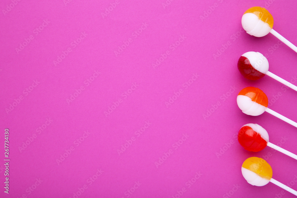 Many colorful lollipop on pink background. sweet candy concept
