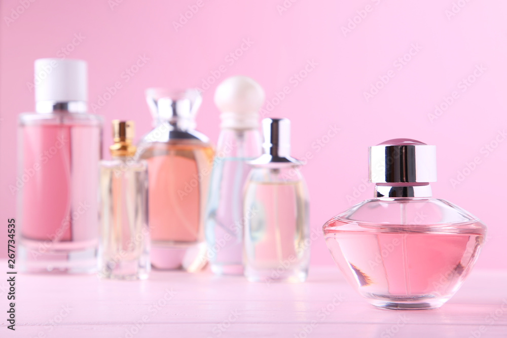 Perfume bottles on pink background, top view Perfume bottles on pink background, top view