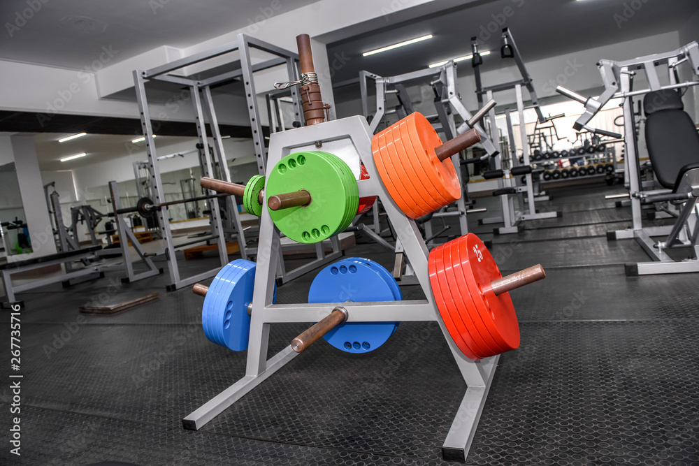 Obraz premium Different colour weights for barbells in gym