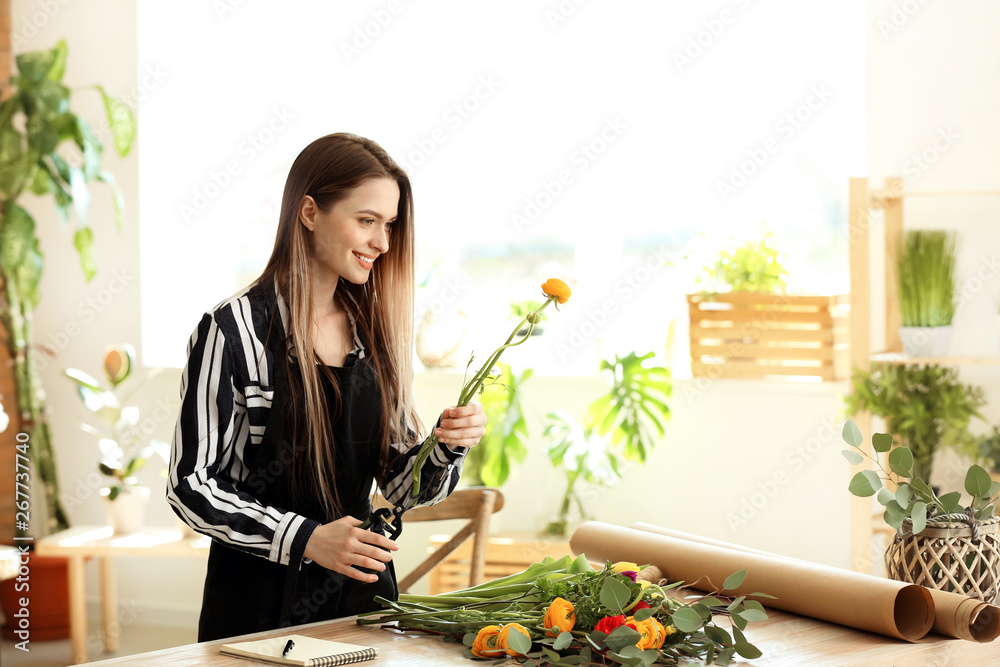 Young florist working in shop