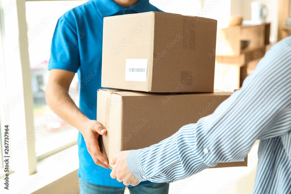 Woman receiving boxes from delivery man Woman receiving boxes from delivery man