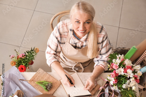 Florist writing in notebook...
