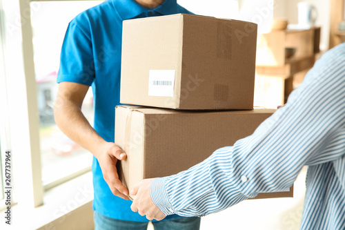 Woman receiving boxes from delivery man