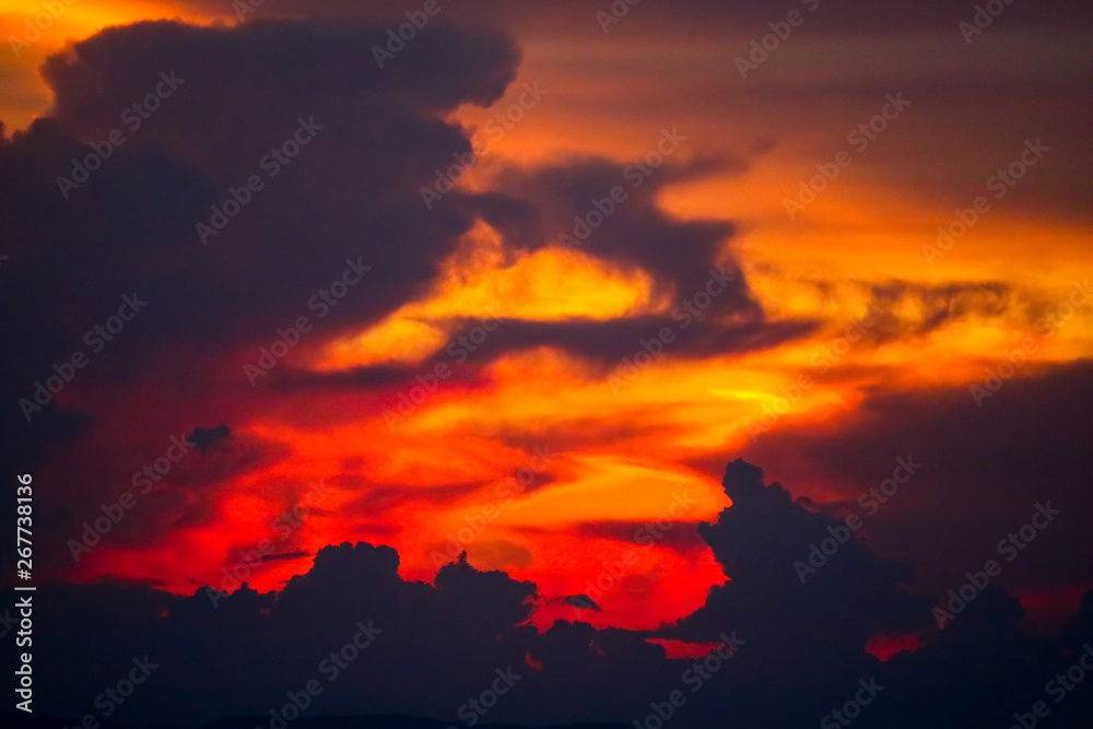multicolor  flame cloud sunset boat on sea and sky