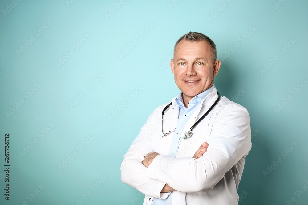 Handsome middle-aged doctor on color background Stock Photo | Adobe Stock