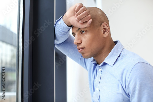 handsome African-American man near window in office