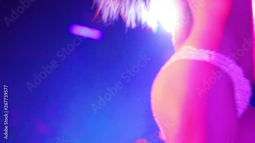 Young sexy woman dancing dance in an intimate setting. Sexy girl with flying hair dancing on a stage in a strip club. 