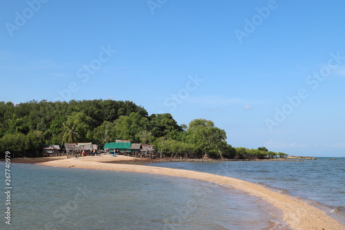 Scenery of beautiful seascape and golden dragon beach and fishery village on island with blue sky background. 