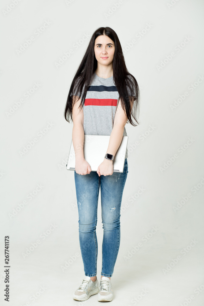 Full length portrait of a happy woman using laptop computer isolated on a white background Full length portrait of a happy woman using laptop computer isolated on a white background