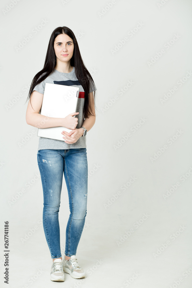 Full length portrait of a happy woman using laptop computer isolated on a white background Full length portrait of a happy woman using laptop computer isolated on a white background