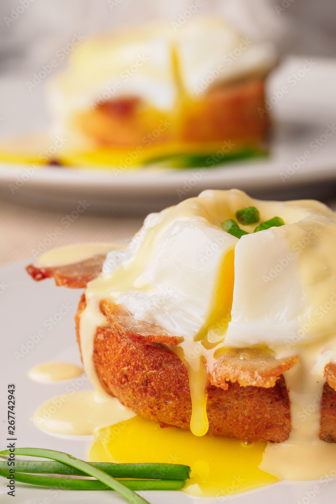 Breakfast is Eggs Benedict - toasted English muffins, bacon, ham, poached eggs, herbs and delicious buttery hollandaise sauce. Breakfast is Eggs Benedict - toasted English muffins, bacon, ham, poached eggs, herbs and delicious buttery hollandaise sauce.