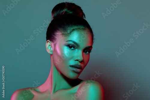 Young Elegant African American Woman in Fashionable Neon Light Background. Glamour makeup. Futuristic  Abstract Blue And Purple Neon Light  Background With Empty Space For Text. - Image  