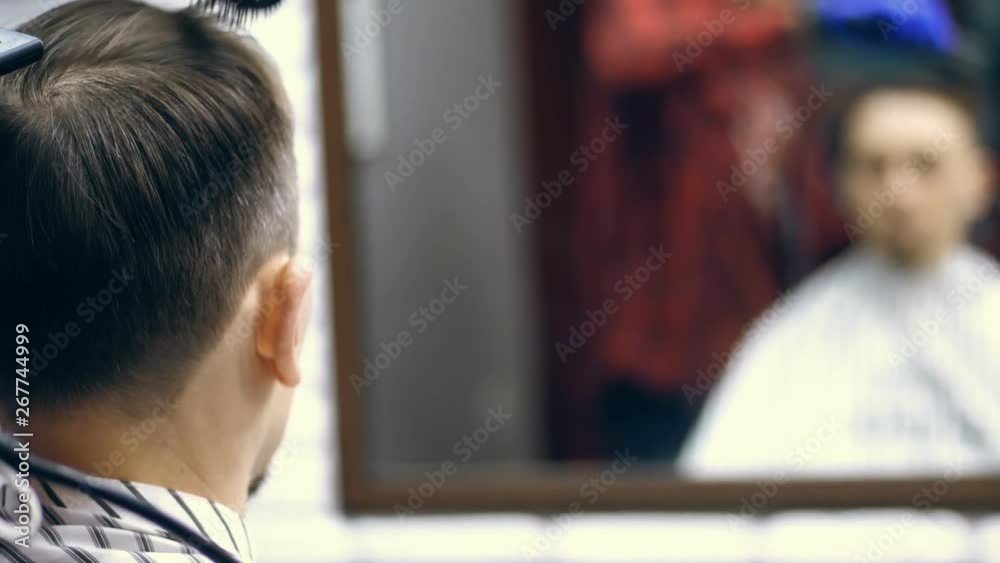 close-up, view from behind, in a baber shop, a men's hair salon, a man's hair cut and styled. close-up, view from behind, in a baber shop, a men's hair salon, a man's hair cut and styled.