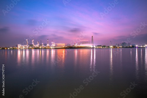 The blurred background of nature along the river, with views of the cargo ship, oil refinery, sunrise and beautiful sky in the morning