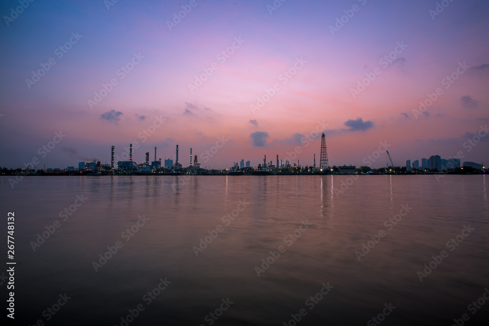 The blurred background of nature along the river, with views of the cargo ship, oil refinery, sunrise and beautiful sky in the morning The blurred background of nature along the river, with views of the cargo ship, oil refinery, sunrise and beautiful sky in the morning
