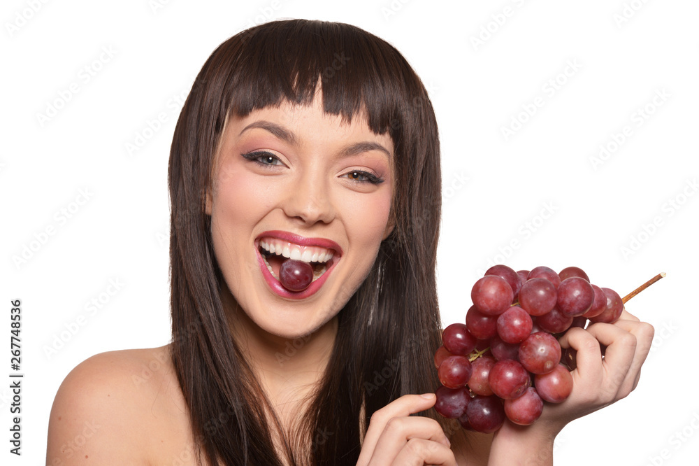 Young woman posing with grapes isolated on white background Young woman posing with grapes isolated on white background