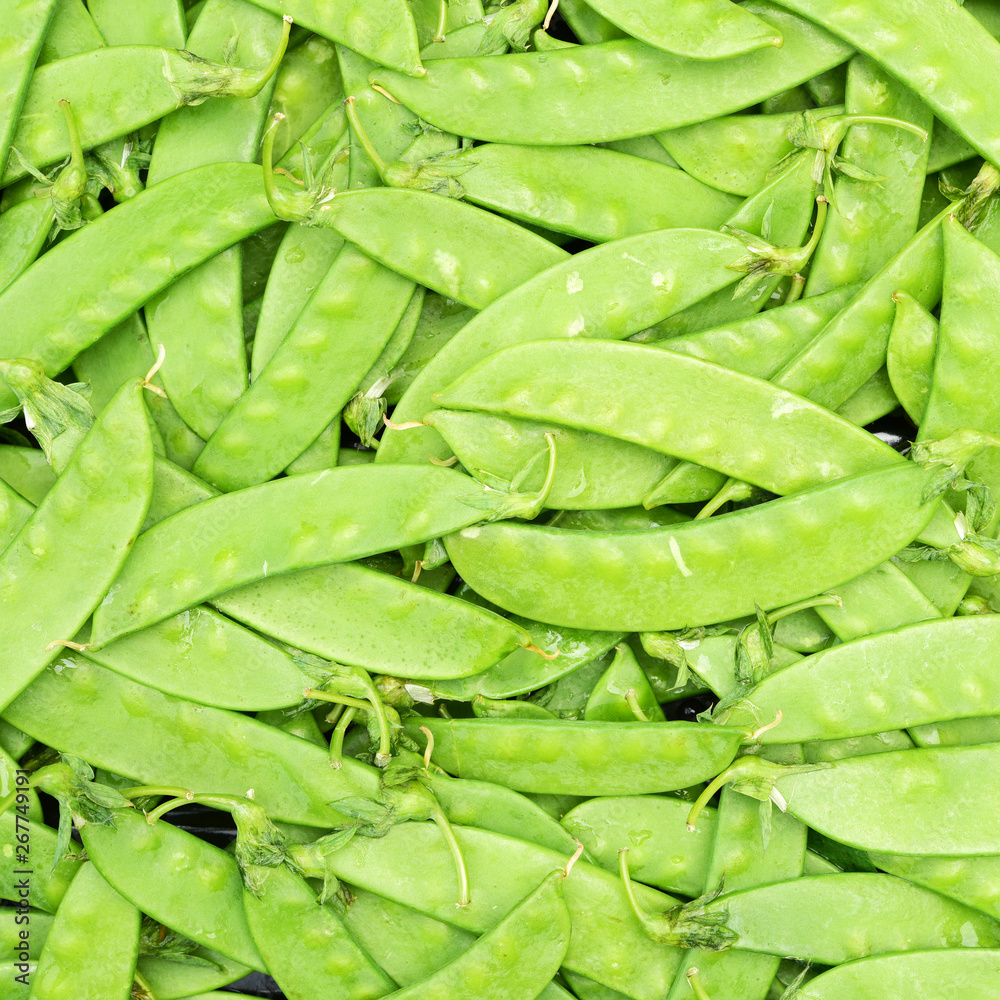 green background of young green peas green background of young green peas
