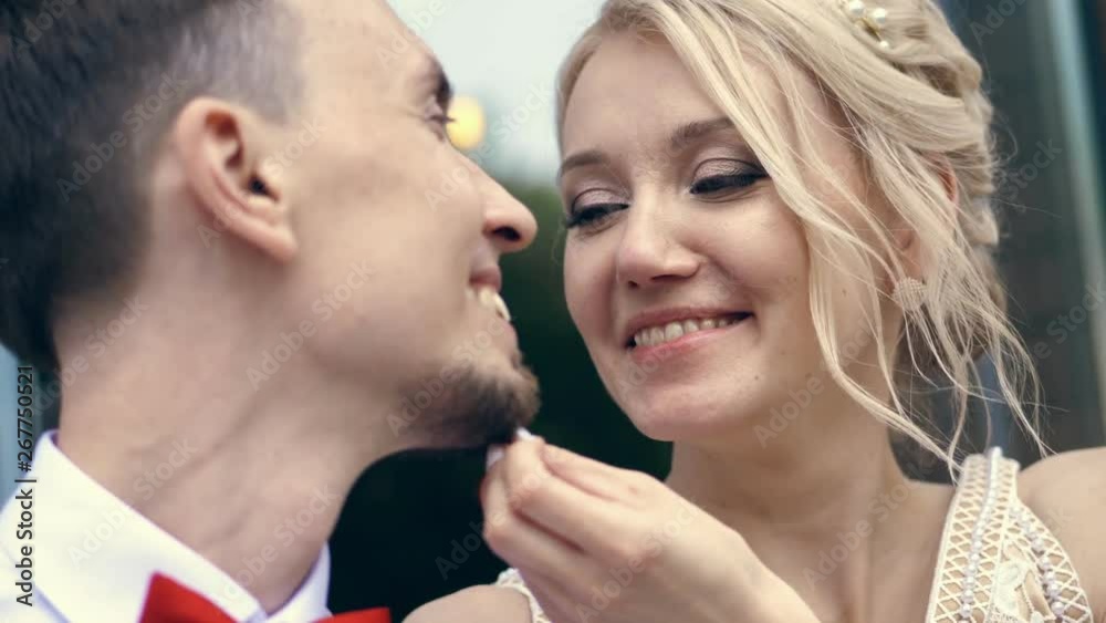 close-up, portrait, the bride gently strokes the groom's beard. Look at each other. wedding. summer day close-up, portrait, the bride gently strokes the groom's beard. Look at each other. wedding. summer day