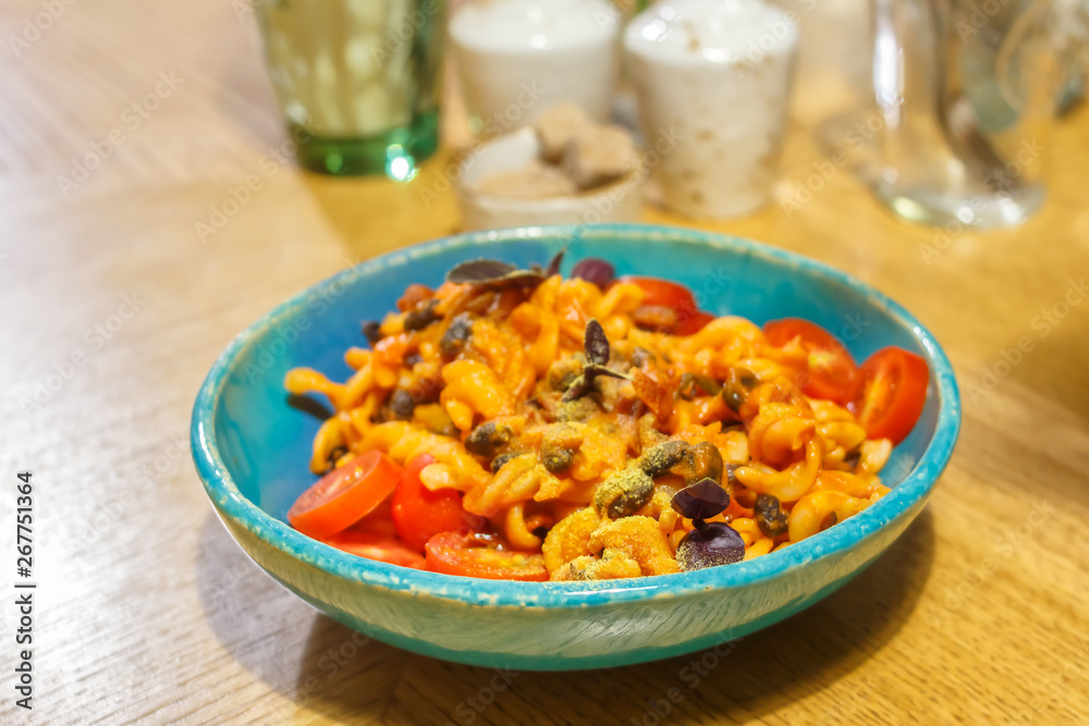 Vegetarian pasta with black beans basil, tomatoes and vegetable cheese. Soft focus. Vegetarian pasta with black beans basil, tomatoes and vegetable cheese. Soft focus.