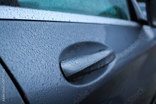 Close up of wet handle of door car after raining. Water drops on a car door handle.