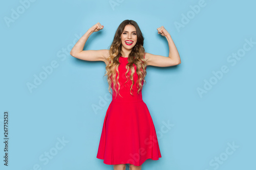 Strong Elegant Woman Is Flexing Biceps And Smiling © studioloco