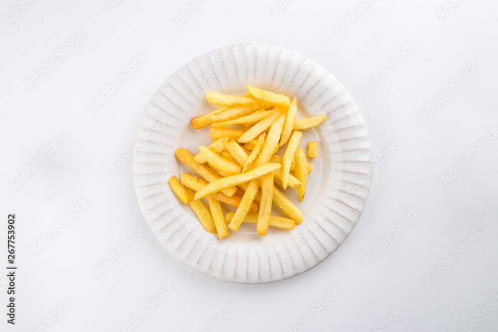 French fries on white plate isolated on white background French fries on white plate isolated on white background