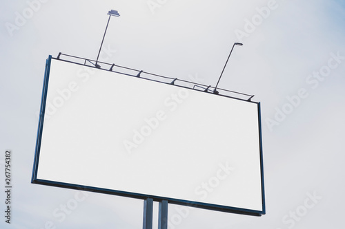 Obraz na płótnie Billboard on the background of a beautiful white cloudy sky. Mock up for your advertising or announcements w salonie