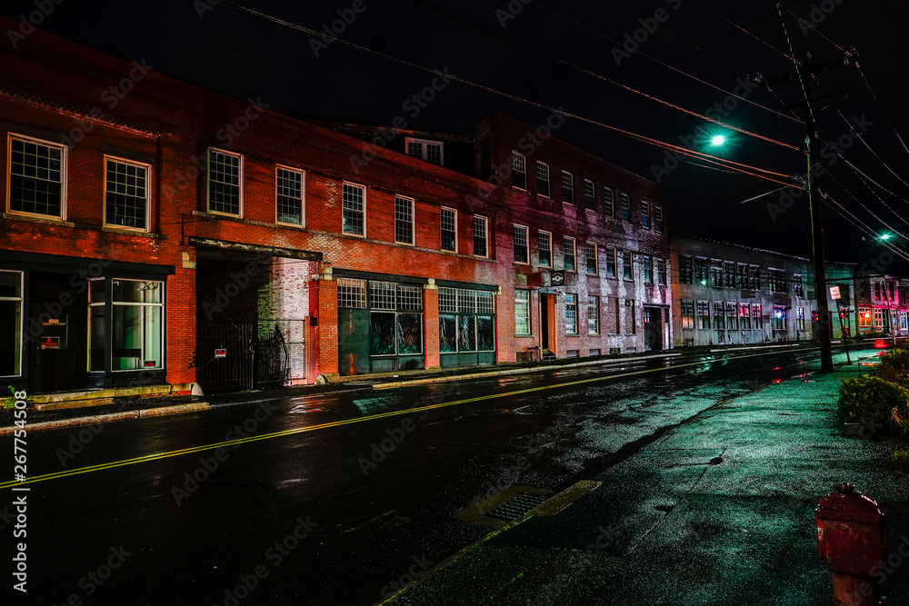 Torrington, Connecticut, USA The old industrial mill town landscape at night on Water Street.