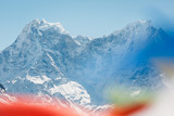 Everest trekking and hiking. Mountains of Nepal. Mountain in focus. Nepalese prayer flags are blurred. Adventure in the Himalayas