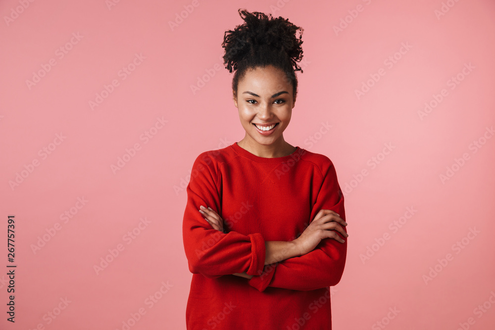 Young happy laughing african woman posing isolated over pink wall background. Young happy laughing african woman posing isolated over pink wall background.
