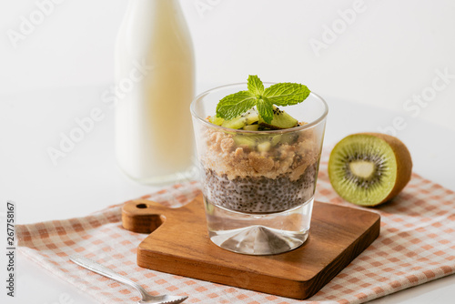 Healthy breakfast with yogurt, nut, kiwi and chia seeds. Bowl of fresh fruit.