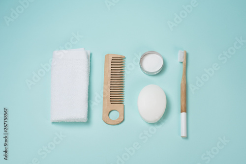 Life in the style of zero waste. Personal care. Towel  calculating  soap  tooth powder  toothbrush on a blue background. No plastic