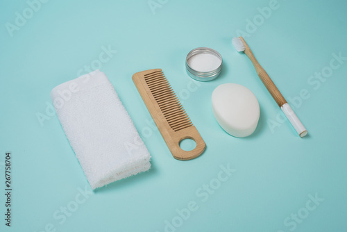 Life in the style of zero waste. Personal care. Towel  calculating  soap  tooth powder  toothbrush on a blue background. No plastic