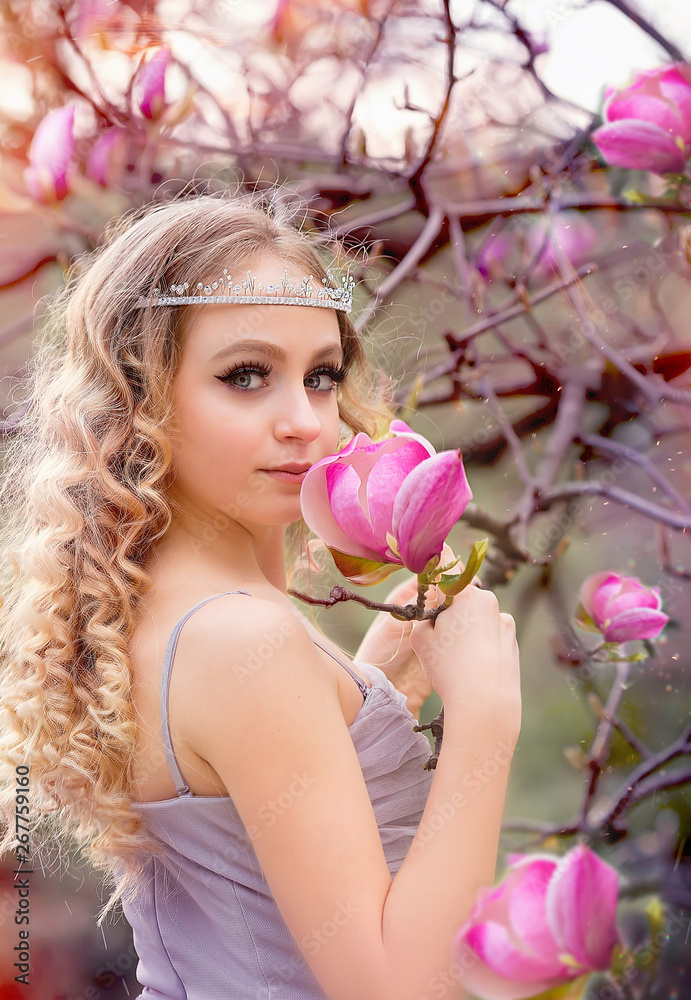 Fototapeta premium girl and magnolia in the garden