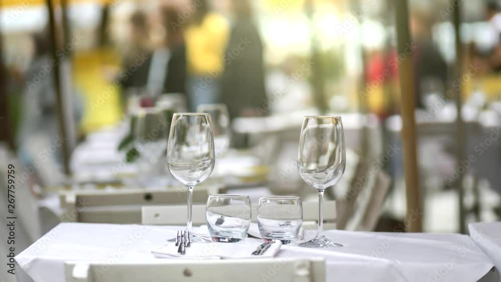Outdoor table with wine glasses. Summer terrace cafe or restaurant with served table set ready for dinner. UHD, 4K Outdoor table with wine glasses. Summer terrace cafe or restaurant with served table set ready for dinner. UHD, 4K