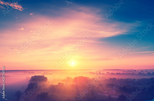 Leinwand Poster Magical sunrise over the lake. Misty morning, rural landscape