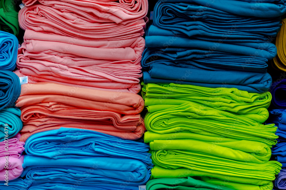 Close up of Colorful t-shirts stacked on shelves