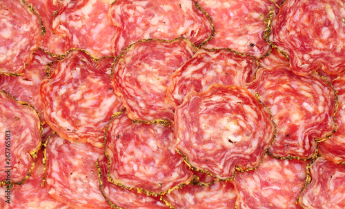 Saucisson Sec French seasoned pork salami meat slices background