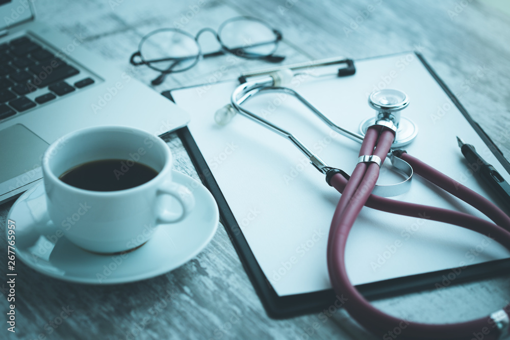 DOCTOR WORKPLACE WITH A STETHOSCOPE ON TABLE CONCEPT DOCTOR WORKPLACE WITH A STETHOSCOPE ON TABLE CONCEPT