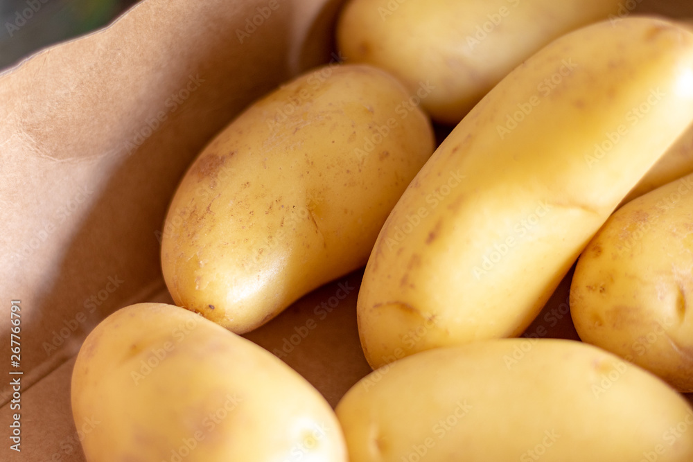 Group of fresh baby potatoes on a wooden table in the kitchen Group of fresh baby potatoes on a wooden table in the kitchen