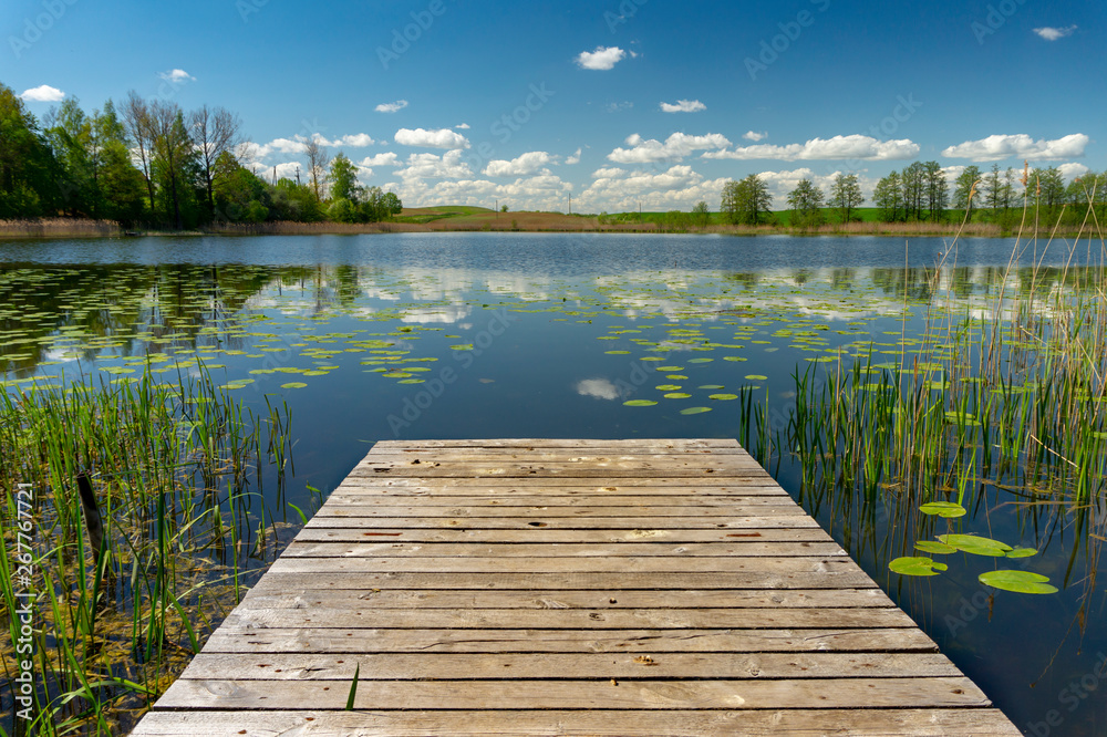 Old rustic wooden jetty on a tranquil lake