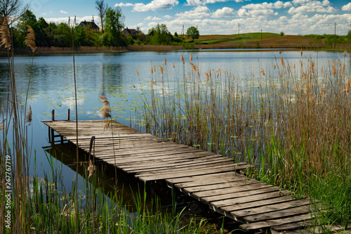 Old rustic wooden jetty on a tranquil lake