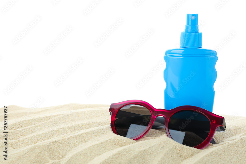Sunscreen with sunglasses on clear sea sand isolated on white background. Summer vacation Sunscreen with sunglasses on clear sea sand isolated on white background. Summer vacation